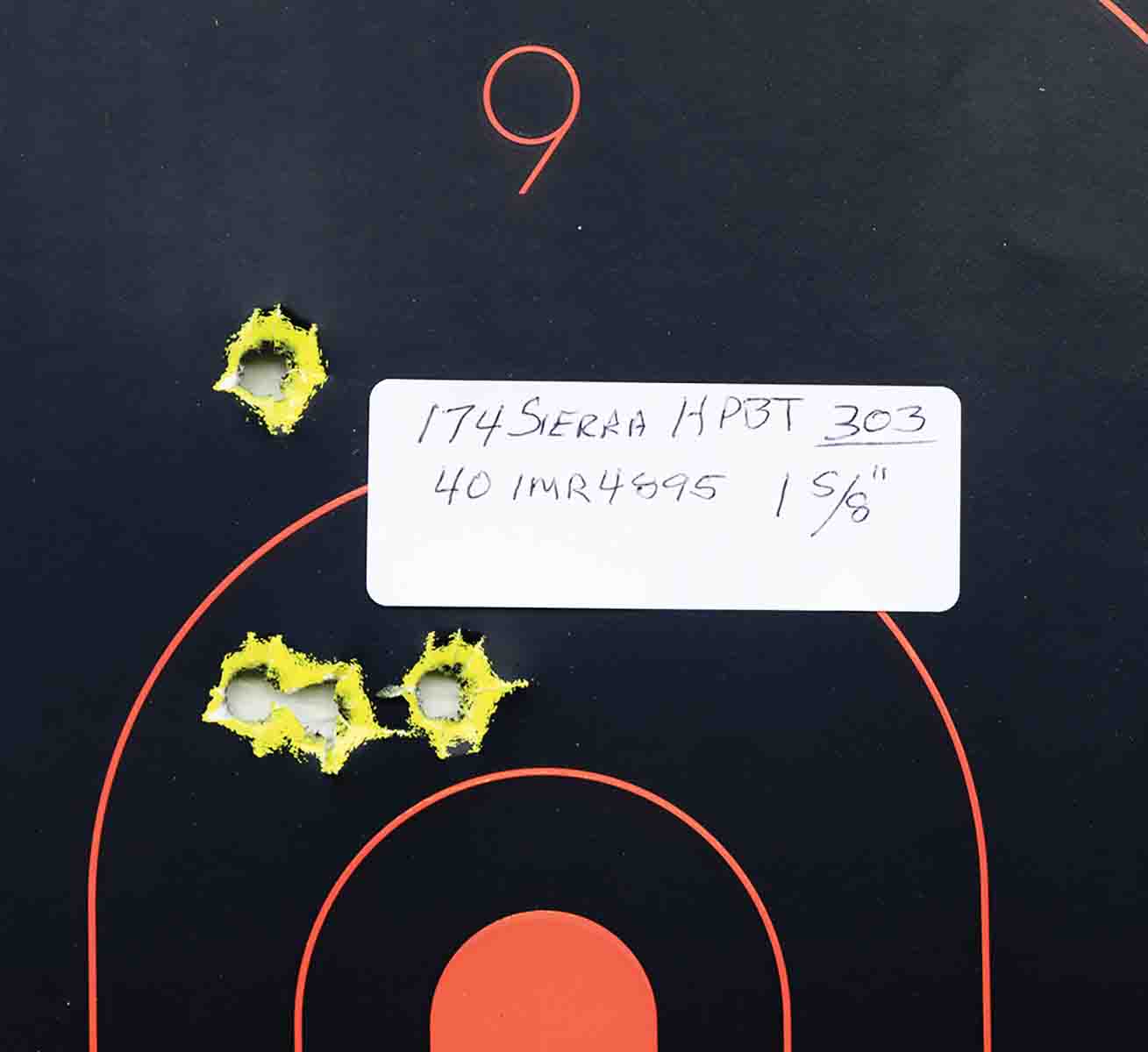 This is a sample group fired with handloads. Note the point of impact left of center.